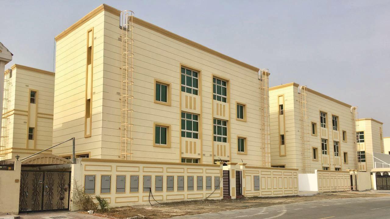 Photograph of cream-coloured multi-level villas in Mirdiff